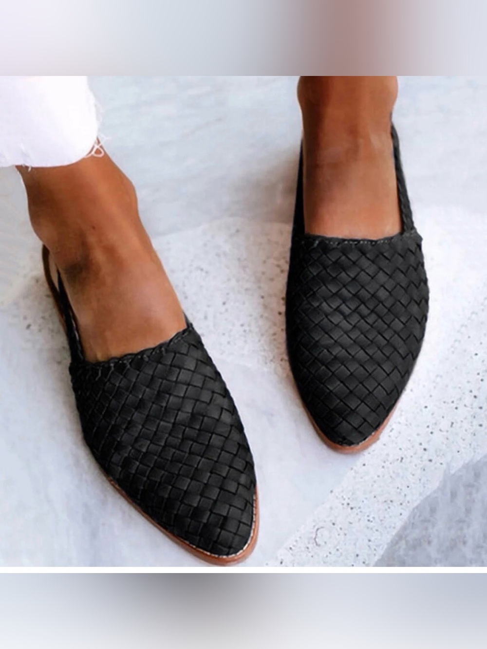 L'intervalle black woven mules featuring a leather sole and slip-on design.